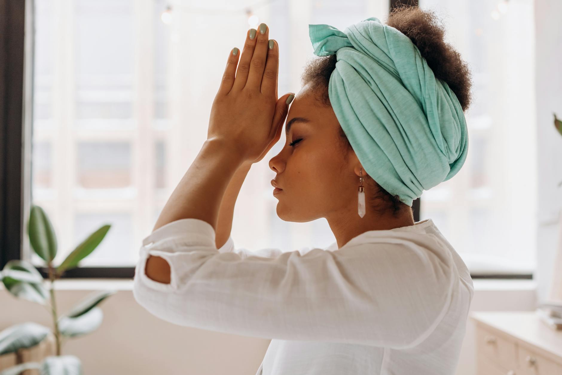 woman in white long sleeve shirt with blue towel on head